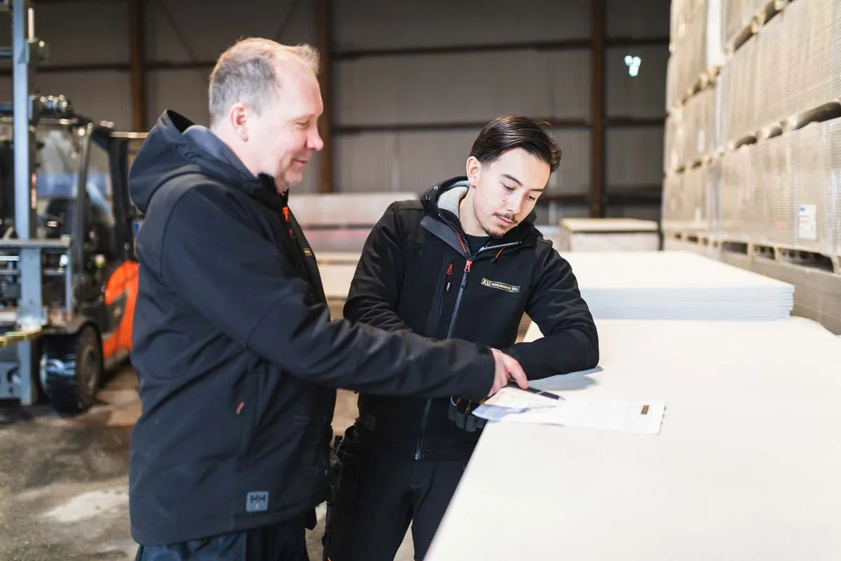 Företagsbild på två kollegor som arbetar i laget, inom byggbranschen.