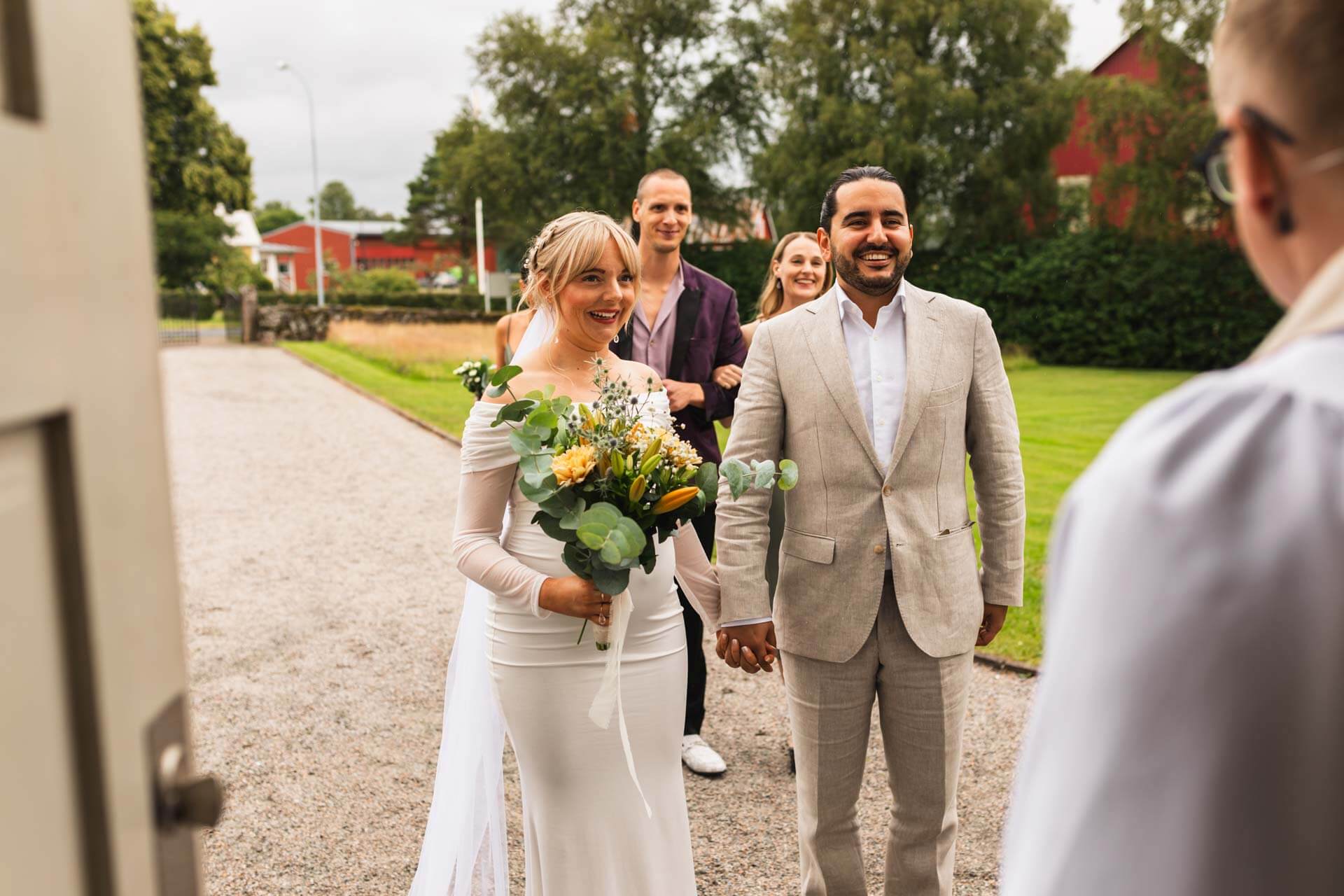 Brudpar påväg in i kyrkan, bröllopsfotograf i Göteborg som fångar vackra bröllopsminnen